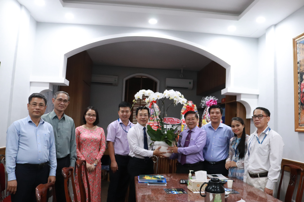 Đại diện nhà trường trao hoa đến đại diện Hội Thánh Tin Lành - Ảnh: PHỐ HƯƠNG